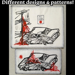 May include: Two white fabric patches with black and red ink designs. The top patch shows a car crash scene with a red 'No Turn On Red' sign. The bottom patch shows a car crash scene with a red star.