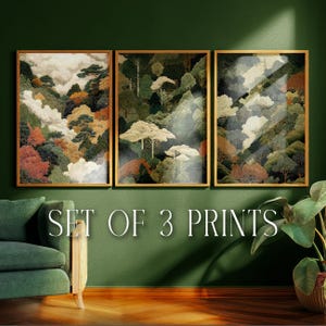 May include: Set of three framed art prints featuring a landscape scene with trees, mountains, and clouds. The artwork has a gold frame and is displayed on a green wall. The text "SET OF 3 PRINTS" is visible.