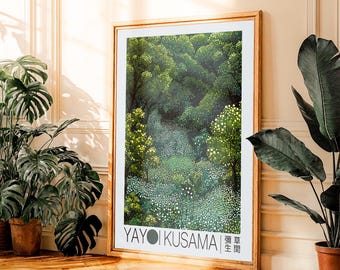 May include: A framed art print featuring a detailed forest scene with varying shades of green and white dots. The artwork is signed "YAYOI KUSAMA" with Japanese text. The frame is a light brown color.