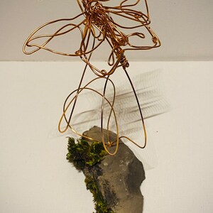 Butterfly copper wire art sculpture mounted on moss slate