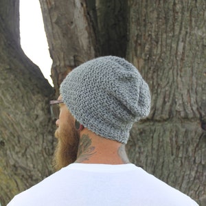 May include: A gray slouchy beanie hat with a textured knit pattern.