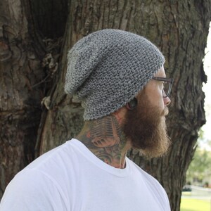 May include: A gray beanie with a slouchy fit. The beanie is made of a soft, textured yarn.