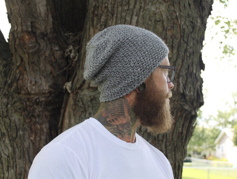 May include: A gray beanie with a slouchy fit. The beanie is made of a soft, textured yarn.
