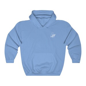 May include: A light blue hoodie with a white floral design of the astrological sign Leo on the front.