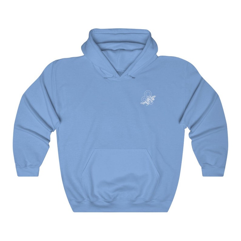 May include: A light blue hoodie with a white floral design of the astrological sign Leo on the front.