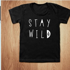 May include: Black t-shirt with white text that reads "Stay Wild" with a small leaf graphic.