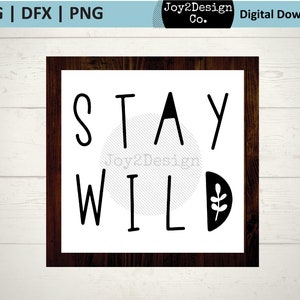 May include: Black and white graphic with the text "Stay Wild" in a modern font. The graphic is framed in a dark wood frame.