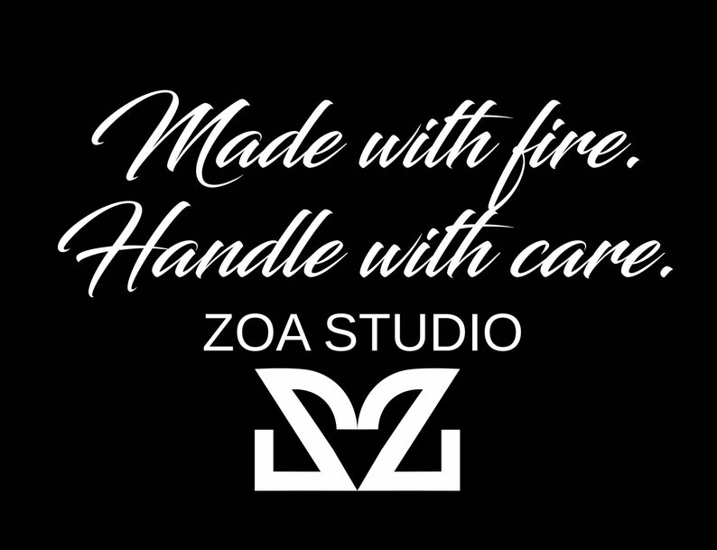 May include: White text on a black background reads "Made with fire. Handle with care." Below the text is the logo "ZOA STUDIO" with a stylized "Z" in white.