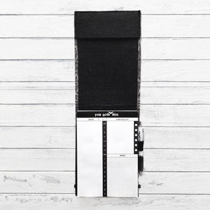 May include: Black leather notepad with a checklist and memo section. The notepad has the text "you got this" printed on the front.