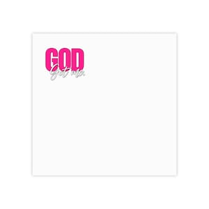 May include: A square white surface featuring the text "GOD" in bold, bright pink capital letters positioned above the word "Got me." written in a thin, black, cursive script font. The design is located in the upper left corner of the white square.