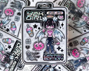 May include: A holographic sticker sheet featuring a cartoon angel girl with pink hair and wings. The sticker sheet also includes a variety of other stickers, including a heart, a phone, a drink, and stars. The sticker sheet is labeled "Y2K Girl" and "Angel Ami" and "Limited Edition".