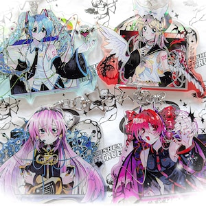 May include: Four anime-style acrylic charms featuring colorful characters with detailed designs. The charms include a blue-haired character, a blonde character with angel wings, a pink-haired character, and a red-haired character. Each charm has a unique pose and expression.