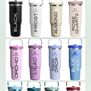 May include: A collection of Stanley 30 oz IceFlow Flip Straw Tumblers in various colors, including black, frost, almond, rose quartz, orchid, lilac, dew drop, blue sky, azure, spring green, coastal teal, and chili red. Each tumbler has a handle and the Stanley logo.