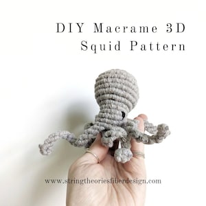 May include: DIY Macrame 3D Squid Pattern. A hand holds a grey macrame squid with eight tentacles.