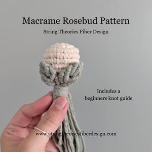 May include: A macrame rosebud pattern with a light green and cream color scheme. The rosebud is held in a hand and has a long tassel. The text "Macrame Rosebud Pattern" and "String Theories Fiber Design" is visible in the image. The text "Includes a beginners knot guide" and "www.stringtheoriesfiberdesign.com" is also visible in the image.