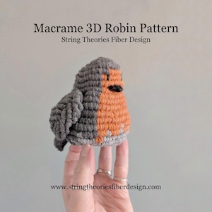 May include: A gray and orange macrame robin bird, a 3D pattern, made with string. The pattern is called "Macrame 3D Robin Pattern" and is by "String Theories Fiber Design". The website address is www.stringtheoriesfiberdesign.com.
