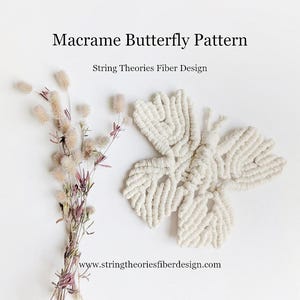 May include: White macrame butterfly wall hanging with a knot pattern. The butterfly is on a white background. The text "String Theories Fiber Design" and "www.stringtheoriesfiberdesign.com" is below the butterfly.