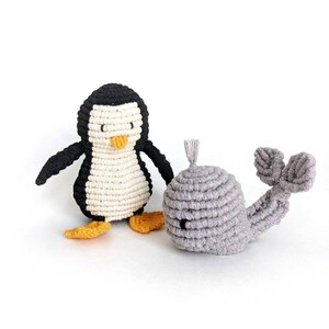 May include: A black and white crocheted penguin toy and a gray crocheted whale toy. Both toys are made with a knotted rope technique.