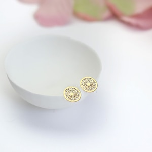 Hypoallergenic ear-safe jewelry, gold mandala studs for a summer look.