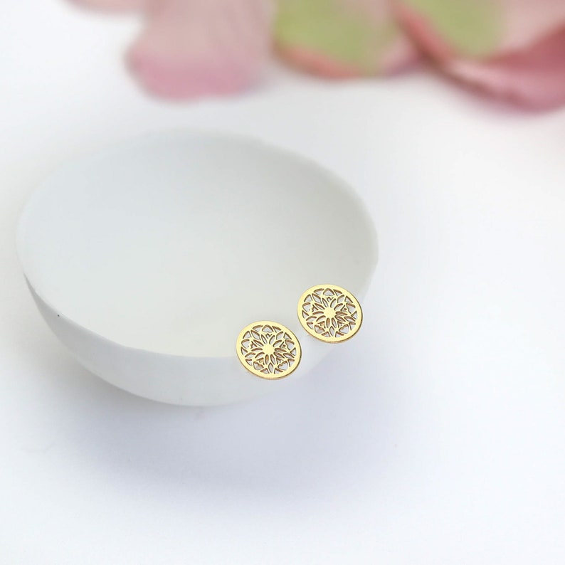 Hypoallergenic ear-safe jewelry, gold mandala studs for a summer look.