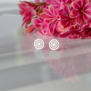 Sterling silver stud earrings feature a detailed geometric design that exudes sophistication and style.