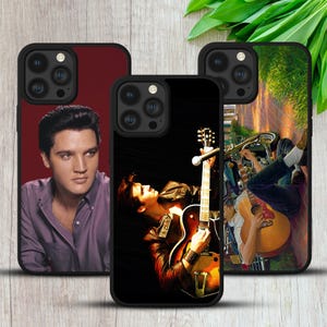 May include: Three black smartphone cases featuring Elvis Presley imagery. The left case shows a portrait of Elvis in a purple shirt. The centre case depicts Elvis playing an electric guitar. The right case shows a person playing an acoustic guitar.
