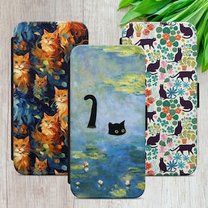 May include: Three rectangular phone cases featuring cat-themed artwork. The left case displays orange cats in a dark blue setting. The centre case shows a black cat swimming in a blue pond. The right case features black cats among colourful flowers.