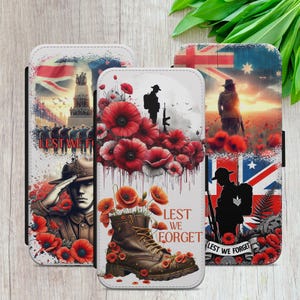 May include: Three phone cases with Remembrance Day themes. One shows a soldier saluting, another a boot with poppies, and the third a soldier in a poppy field with a flag. The text "Lest We Forget" is displayed on each case.