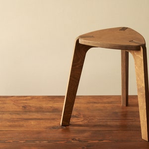 Stool, wood three-legged stool in brown, chair, plywood furniture. kids stool