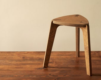 Stool, wood three-legged stool in brown, chair, plywood furniture. kids stool