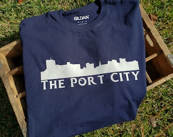 Camiseta de Wilmington, Carolina del Norte - La ciudad portuaria - Cape Fear - Playas de Wilmington - Verde azulado - Piratas - Horizonte del centro