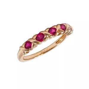 Op de afbeelding: Een gouden ring met vijf rode robijn edelstenen gezet in een gedraaide band.