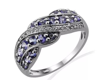 May include: A silver band ring with a twisted design. The ring is set with small purple and white gemstones.