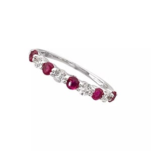 May include: A delicate white gold band ring with alternating red rubies and white diamonds.