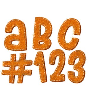 May include: Orange felt letters and numbers with white stitching. The letters are A, B, and C. The numbers are 1, 2, and 3. There is also a number sign (#).