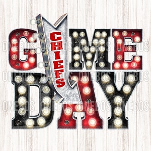 May include: A red, white, and black sign with light bulbs that reads "GAME DAY" with a red arrow pointing down that says "CHIEFS".