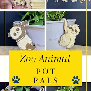 May include: Wooden zoo animal pot pals in various designs, including a lion, panda, and sloth. The image shows the pot pals hanging on the edge of a white pot with a green plant. The text "Zoo Animal POT PALS" is displayed.