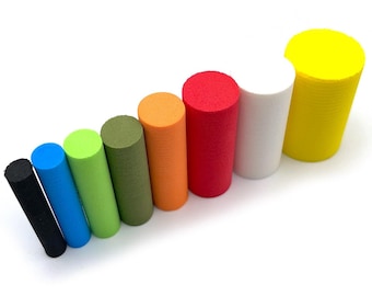 May include: A collection of colorful cylindrical foam pieces in various colors, including black, blue, green, olive, orange, red, white, and yellow. The cylinders are arranged diagonally against a white background, showcasing their diverse hues and textures.