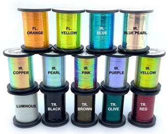 May include: A collection of spools of iridescent thread in various colors, including orange, yellow, blue, copper, pearl, pink, purple, and red. Each spool is labeled with its color and type, such as "FL. ORANGE" and "IR. BLUE".