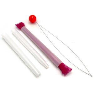 May include: A collection of craft tools, including two white plastic tubes, a pink and purple tool with a red ball and a thin wire, and a pink brush. The tools are arranged on a white surface.