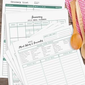 May include: A stack of printable meal planner pages with a green and white design. The pages include a grocery list, meal ideas, and a calendar for January 2019. The text "17 Pages" and "US, UK, AU Holidays" is visible in the lower right corner of the image.