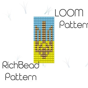 Peut inclure: Un motif de perles pour métier à tisser représentant un drapeau ukrainien avec un fond jaune, une bande bleue et un trident brun. Le motif est intitulé "RichBead Pattern" et "LOOM Pattern".