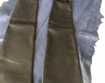 May include: A pair of long black leather gloves with a black cuff and silver accents.