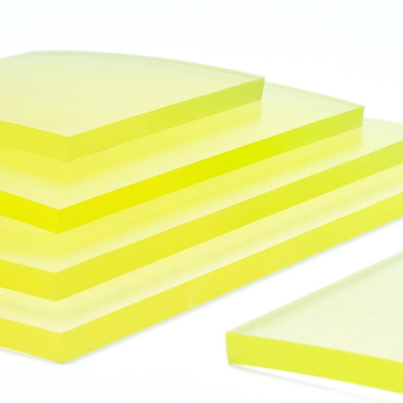May include: Stack of five translucent yellow acrylic sheets, with one sheet angled in the foreground.
