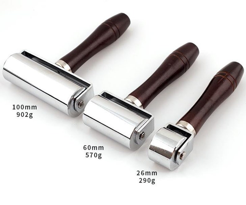 May include: Three chrome-plated leather rollers with wooden handles. The rollers are 100mm, 60mm, and 26mm in diameter. The weights are 902g, 570g, and 290g.