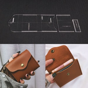 May include: A brown leather wallet with a snap closure, shown closed and open, revealing the interior. Above, a clear acrylic template for crafting the wallet is displayed, featuring cut lines and markings for precise construction.