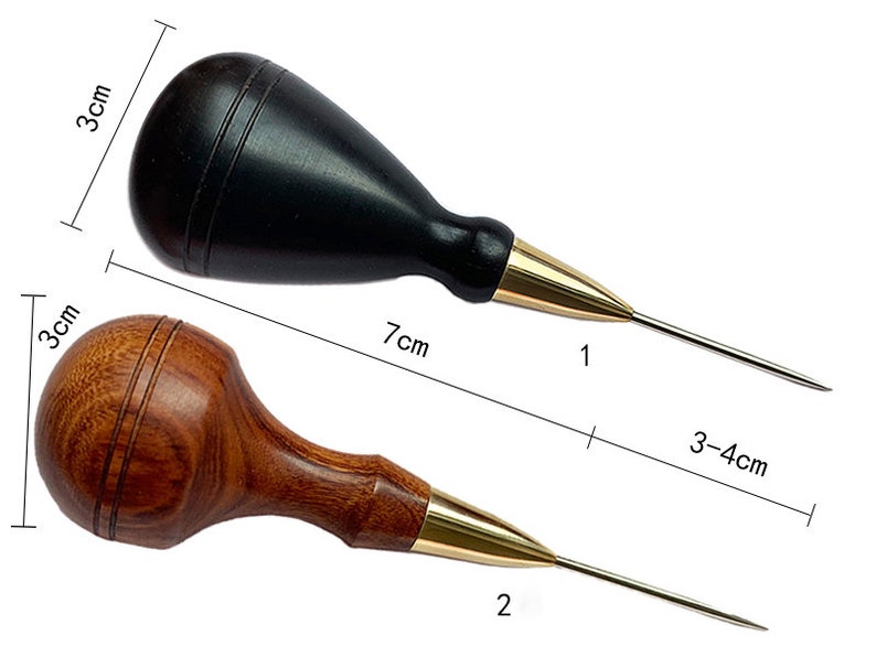 May include: Two leather awls with wooden handles. The awl on the left has a black handle and is 7 inches long. The awl on the right has a brown handle and is 7 inches long. Both awls have a gold metal tip.