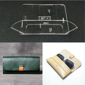 May include: A leather glasses case with a snap closure and a stitched design. The case is made of light brown leather and is shown with a pair of sunglasses inside. A green leather wallet is also shown in the image.