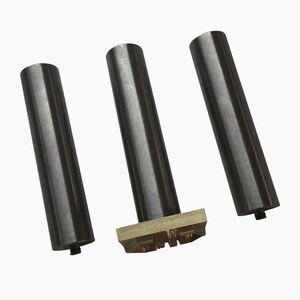 May include: Three black metal stamp handles with a brass stamp head featuring a design of letters.