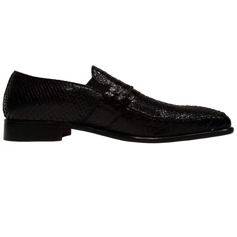 May include: Black leather slip-on shoes with a snakeskin pattern.